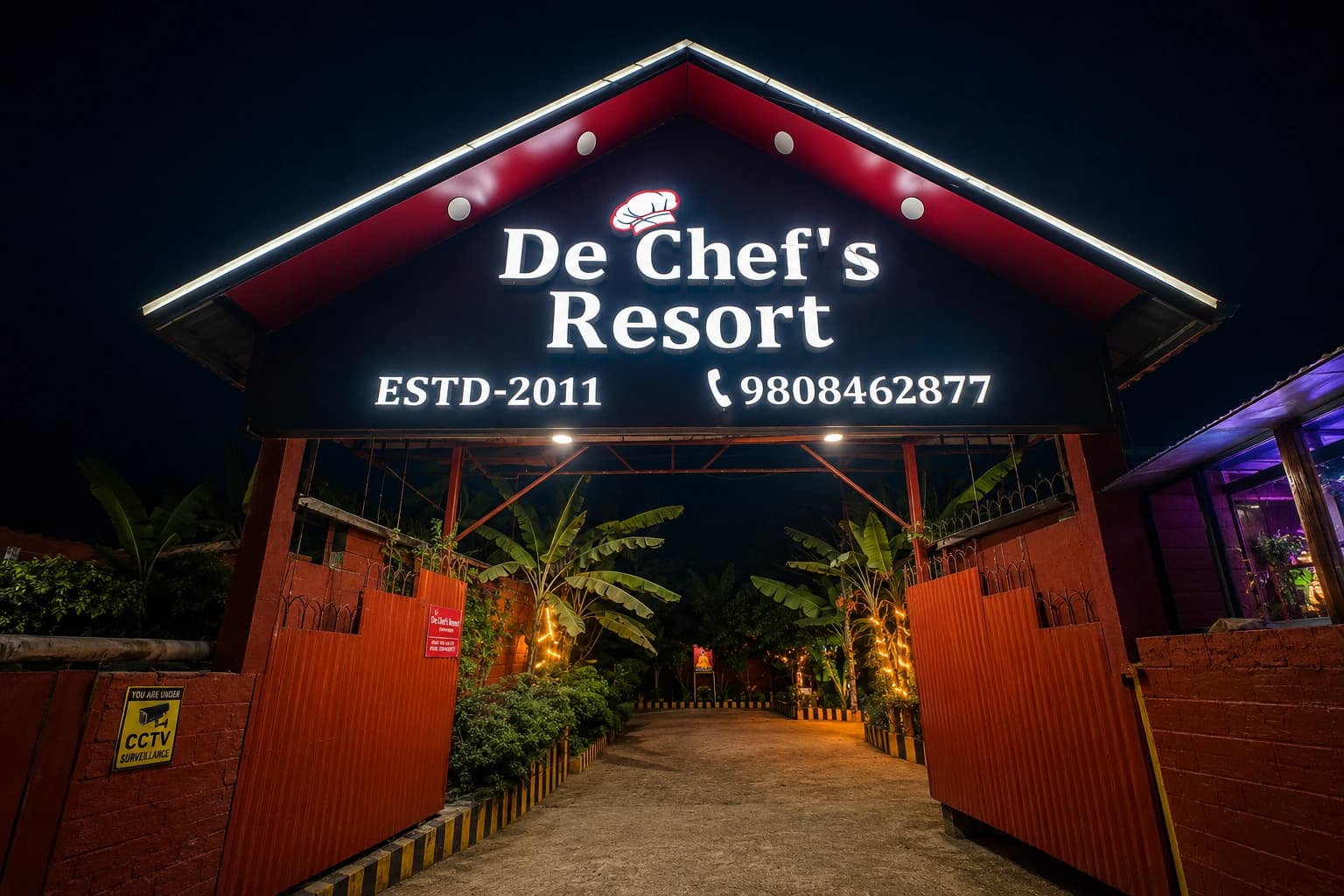 De Chef's Resort illuminated entrance sign at night